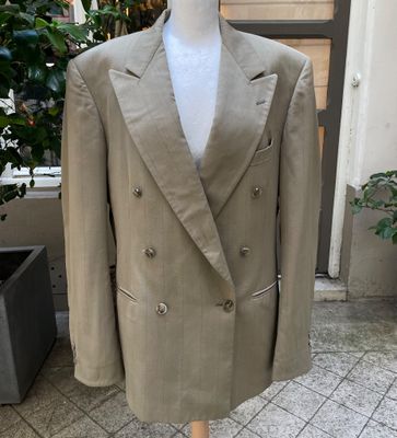 a close up of a suit on a mannequin on a stand