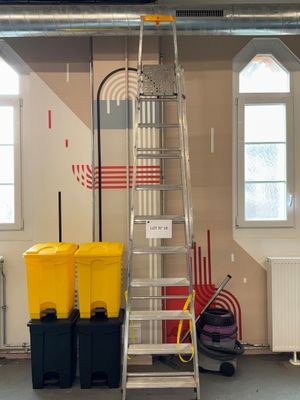 a picture of a room with a ladder and two bins