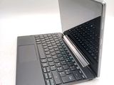 a laptop that is open on a white surface
