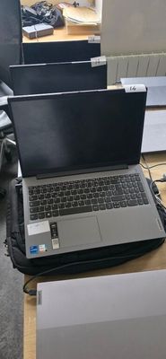 a laptop computer sitting on top of a wooden desk