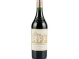 a close up of a bottle of wine on a white surface