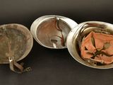 three metal pans are sitting next to each other on a table