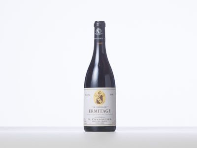 the bottle of wine is sitting on the table on the table