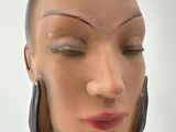 a mannequin of a woman with her eyes closed
