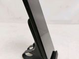 a cell phone that is on a stand on the table