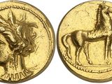 a close up of a gold coin with a horse on it