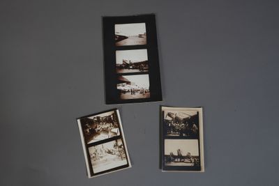 Plusieurs photos de personnes sont accrochées au mur d'une pièce