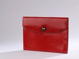 a red lizard skin wallet with a gold clasp