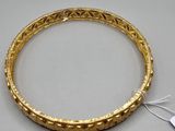 a close up of a gold bracelet with a tag on it