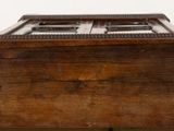 a small wooden box with a window on top of a table