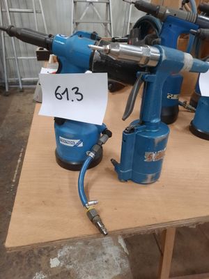 two electric drillers on a table with price tags on them