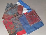 four different colors of handkerchiefs on a table