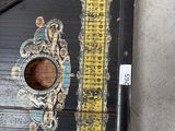 a black and yellow birdhouse with a ruler on it