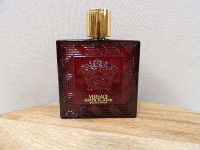 a close up of a bottle of perfume on a wooden table