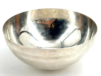 a silver bowl that is sitting on a white surface