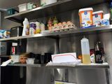 a woman that is standing in a kitchen preparing food