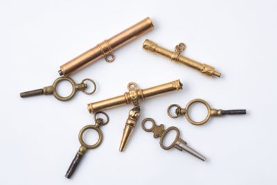 several antique keys are arranged in a circle on a white surface
