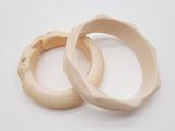pair of carved ivory bangles on a white background
