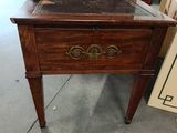 a wooden table with a drawer on top of it