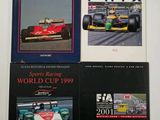 three books on a white surface with a picture of a racing car