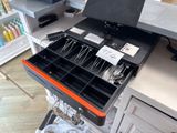 a drawer full of utensils in a store