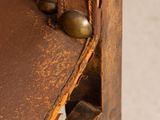 a close up of a chair with a leather seat