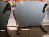 two chairs sitting next to each other on a tiled floor