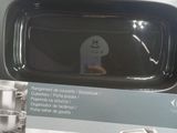 someone is holding a box with a microwave on it in a store