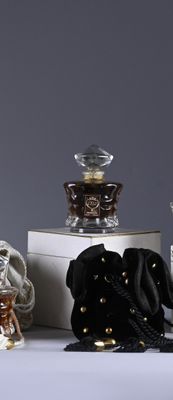 several different types of perfumes are displayed on a white table