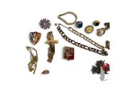 many different types of jewelry on display on a white surface