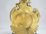 an image of a gold clock on a stand on a white background