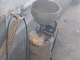a tank with a metal tank and a broom next to it