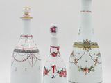 three white vases with different designs and designs on them on a white surface
