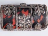 a silver and black box with a red and black design
