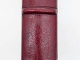 a red leather case that is on a white surface
