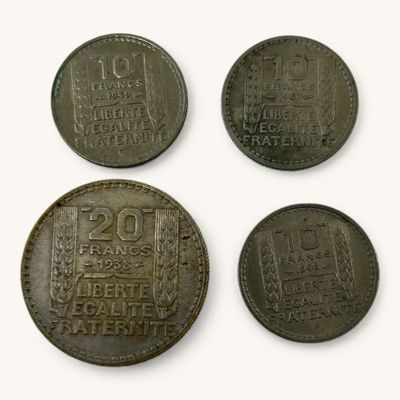 four different coins are shown in a row on a white surface