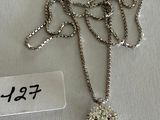 a close up of a necklace with a tag on it