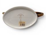 an oval white plate with a brown handle on a white surface