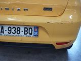 a close up of a yellow car with a license plate on it