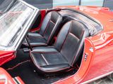 an image of a red convertible car with its doors open