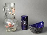 two vases and a bowl sitting next to each other on a table