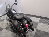 a black motorcycle that is parked on a checkered floor