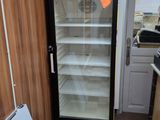 a refrigerator that is sitting in the corner of a kitchen