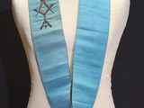 an image of a blue sash on a mannequin with a red rose