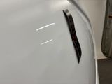 a sticker on the hood of a white car