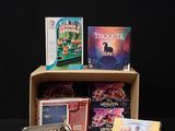 a lot of cards and games in a cardboard box