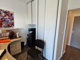 a room with a desk and a chair in it