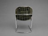 a chair that has a bag on it on a metal stand