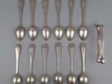 six silver spoons and two silver spoons on a table