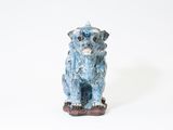a small statue of a dog that is sitting on a table